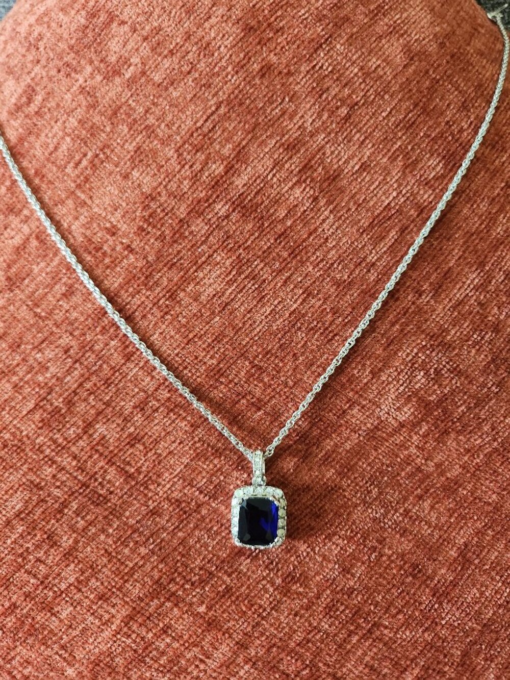Silver chain necklace with a sapphire-colored pendant